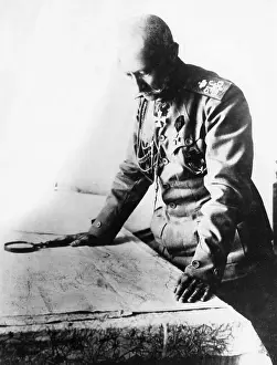 Magnifying: German army officer examining a map, WW1