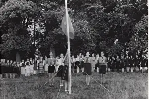 Guides: German boy scouts saluting Guide flag at camp