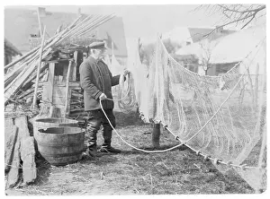 Mending: A German fisherman mending his nets