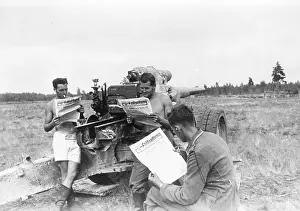Artillerymen: German gun crew reading the newspaper, 1941