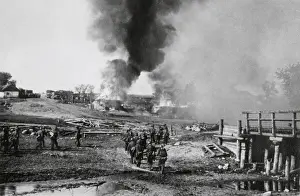 Lcgr1406: German infantry advancing on a burning village in