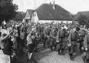 Cheered: German infantry marches through a village during a maneu