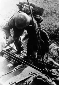 Sturmgeschuetz: German infantryman before an assault gun on the Eastern