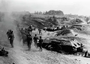 Downed: German infantrymen go past downed tanks, 1941