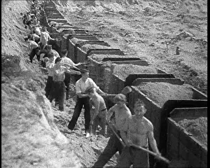 Shovelling: German Men Shovelling in a Ditch