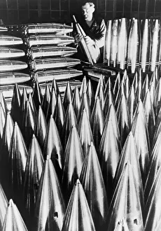 Rs5wnlcgr: German munitions worker inspecting large shell