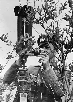 Scissor: A German officer makes camera shots, 1942