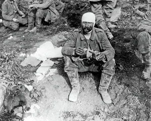 Bandaged: German POW enjoying some bully beef, WW1