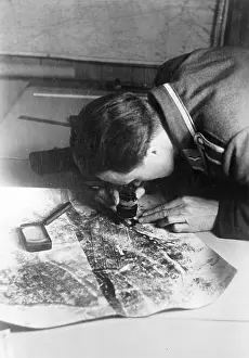 Magnifying: German soldier analyses reconnaissance images, 1941