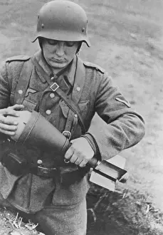 Positioned: German soldier with a bazooka shell, 1944