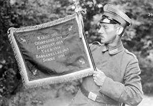 Booty: German soldier with captured enemy flag, 1917