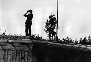 Begun: German soldier on a conquered bunker, 1941