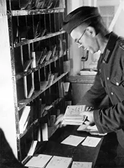 Pigeonholes: German soldier in a field post office, WW2
