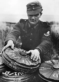 Stacks: German soldier with mines, 1944