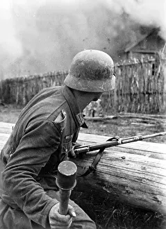 Midst: German soldier ready to attack on the Eastern front, 1941