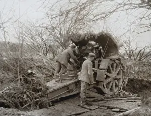 Accounting: German Soldiers at a camouflaged Howitzer during