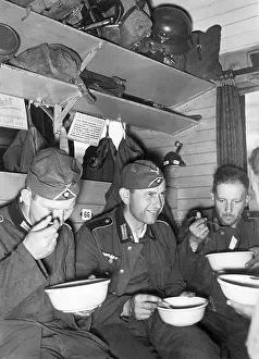 Spooning: German soldiers eat in the train compartment, 1941