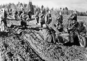 Morass: German soldiers push a motorcycle with a sidecar which stran