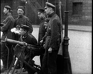 Placement: German Soldiers Standing and Smoking By A Machine
