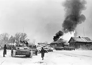 Contested: German tanks and vehicles in a village on the Eastern Front