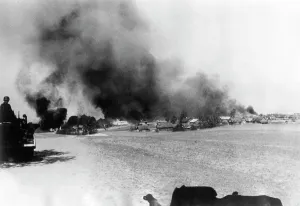 German Soviet: German troops in front of a burning city on the Eastern