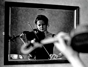 Seopedi: Gina Beukes, violinist, playing in front of a mirror