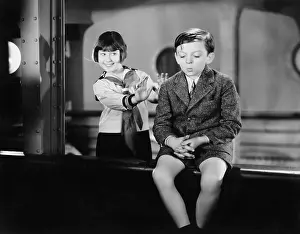 Terrify: Girl behind a boy pretending to push him overboard