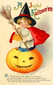 Costumed: A girl costumed as a witch stands inside a Jack O Lantern