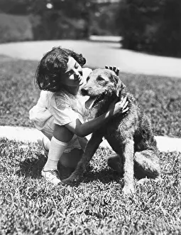 Mutt: Girl crouching down to pet her dog