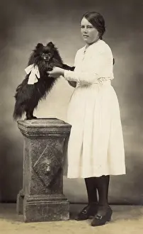 Lapdog: Girl with dog in studio photo