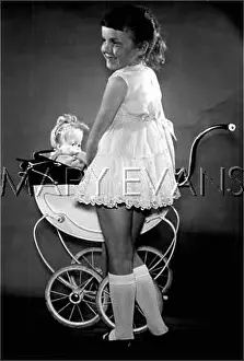Protectively: GIRL WITH DOLL IN PRAM