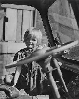 Girl in the doorway of a lorry or van
