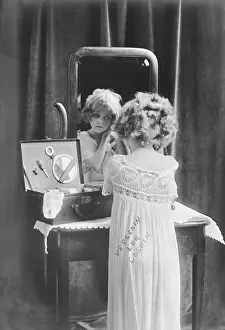 Primping: Girl dressing up in front of mirror