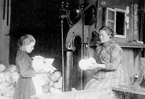 Helps: A girl helps her mother at work, 1910