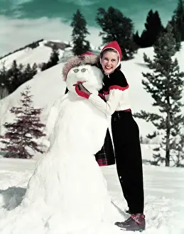 Snowmans: Girl Leaning On A Snowman