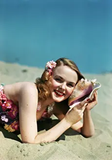 Conch: Girl Lying On Beach With Conch Shell