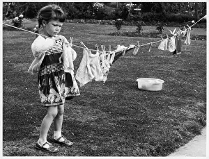 Laundry: GIRL PEGGING OUT CLOTHES