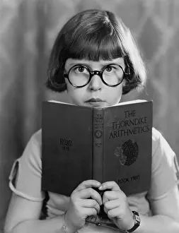Literacy: Girl studying hard reading book