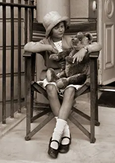 Quizzical: Girl with teddy bear