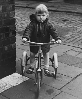 Cobblestones: Girl on a tricycle