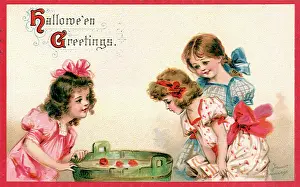 Bobbing: Girls bobbing for apples in a barrel