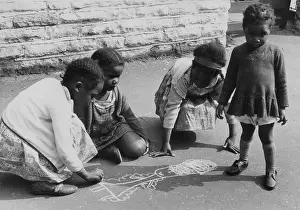 Chalking: Four girls chalking on the pavement
