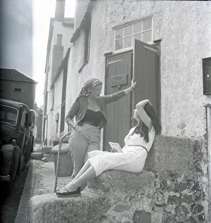 Studies: Girls chatting on the steps of The Cabin, St Ives, Cornwall