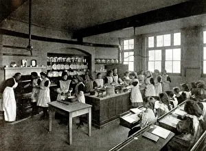 Aprons: Girls in a classroom having a cookery lesson