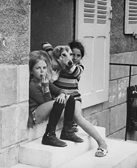 Doorstep: Two girls and a dog on a doorstep