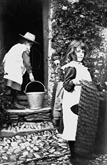 Housework: Two girls help their mother with the housework