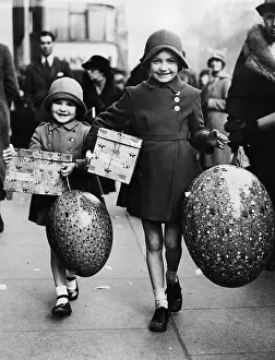 Easter: Two girls with huge Easter eggs
