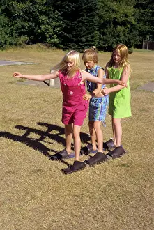 Pre Teen: Three Girls in Three Legged Relay Game