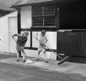 Tony Boxallfrps: Two girls mopping and sweeping up