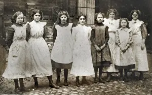 Smocks: Girls outside a (clothes-making?) workshop